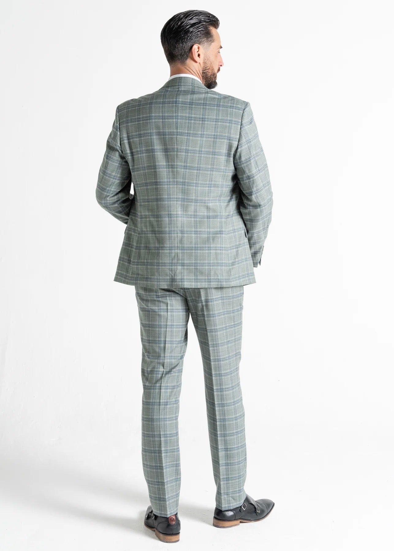 Model wearing Kensington Olive Suit has back to the camera, showing reverse details of suit.