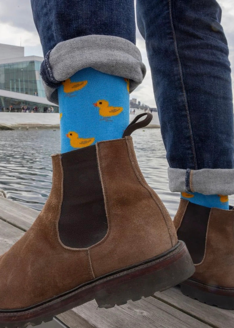 Bamboo socks for men, men's bamboo socks with rubber duck patterns. Duck socks shown on model.
