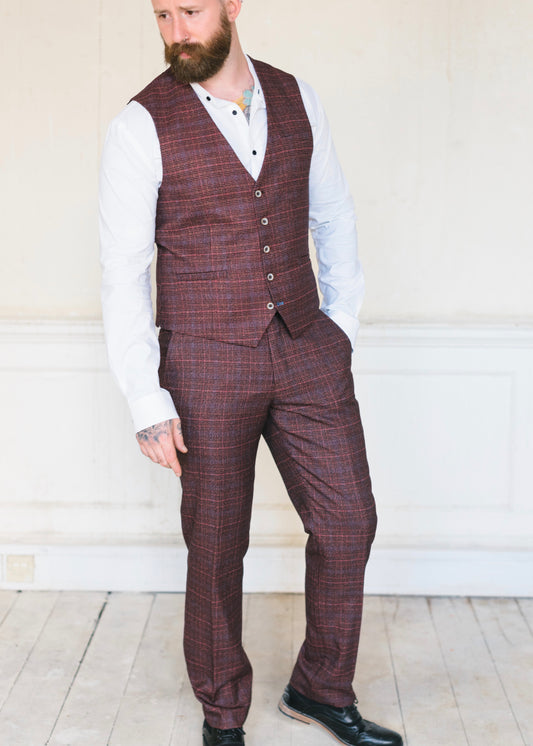 Cavani Carly Wine 2-Piece Suit consisting of trousers and waistcoat worn with a crisp white shirt and black shoes. Ideal for a wedding or another formal event or occasion.