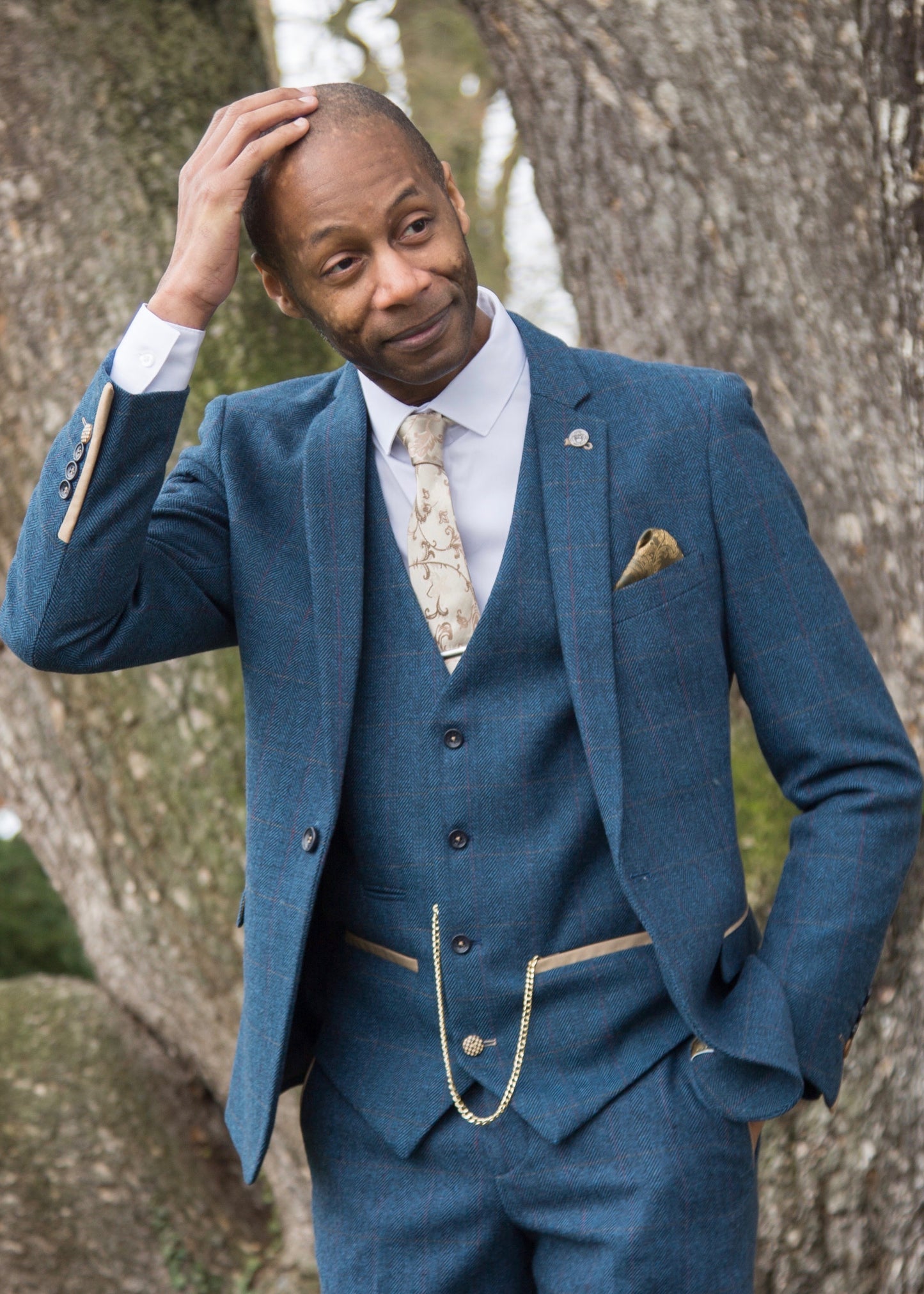 BAME model wearing Marc Darcy Dion Tweed Jacket styled with matching waistcoat and trousers. Model also wearing tie to compliment the finer details of the suit and a crisp white shirt.