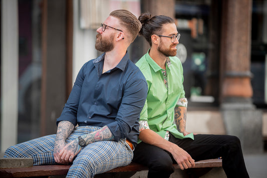 Gentleman sitting on bench wearing smart casual fashion wear.