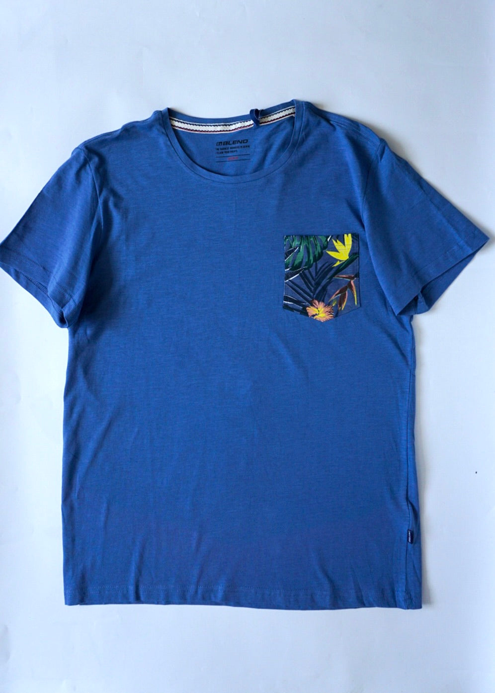 True blue men's short sleeve t-shirt with colourful summer pattern left chest pocket detail.