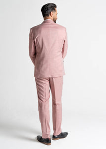 Model wearing Pastel Pink Edward Suit has his back to the camera, showing reverse details of men's pink suit.