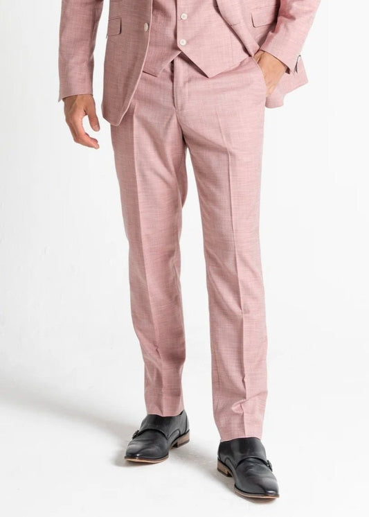 Model wearing Edward Pastel Pink suit faces toward camera showing front details of the pink suit for men.