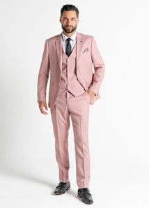 Model wearing Pastel Pink Edward Suit faces the camera wearing all three pieces of his pink suit for men.