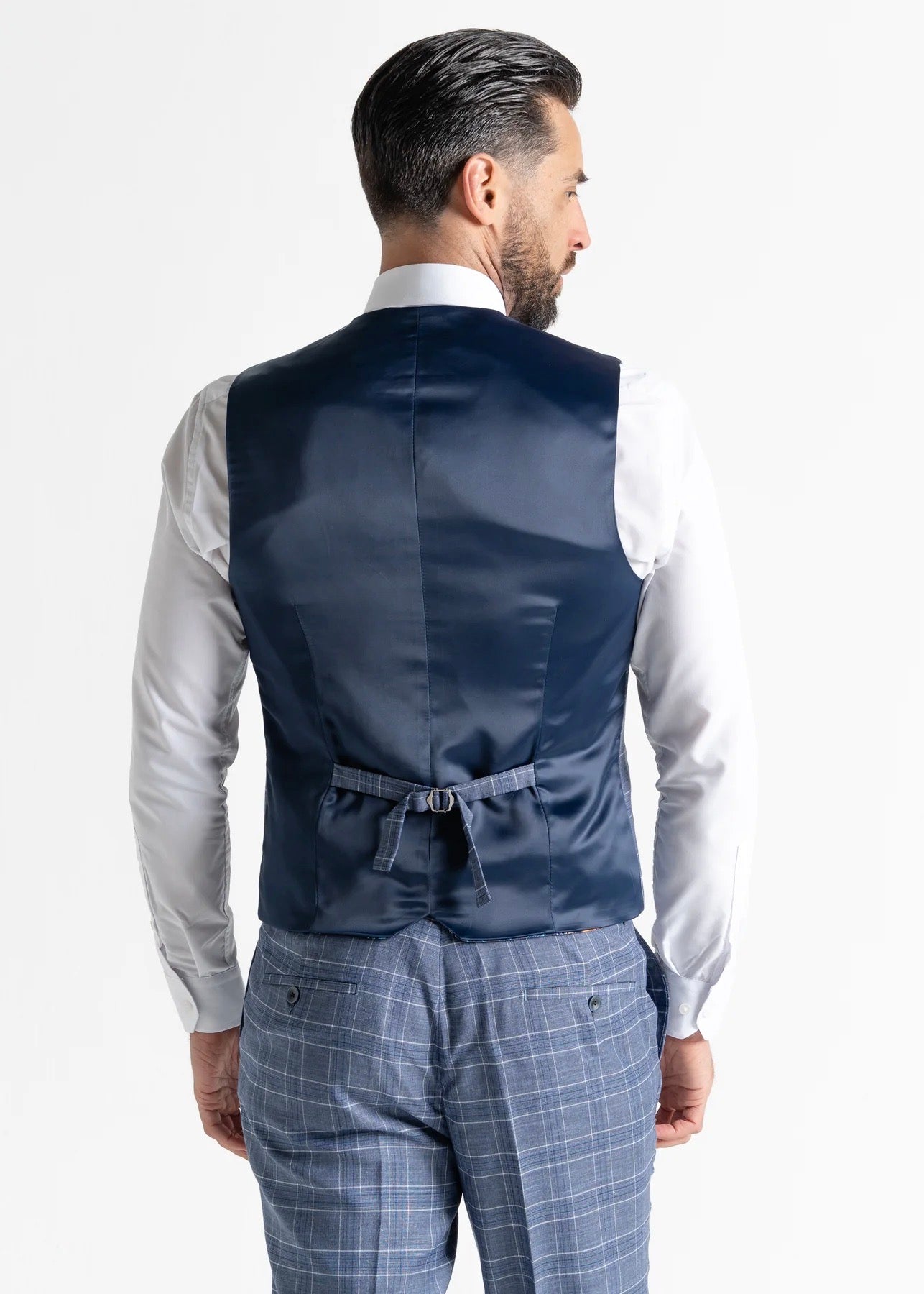 Model wearing Kensington Light-Blue Waistcoat and Trousers has a close up of back of his outfit. 