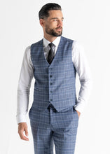 Load image into Gallery viewer, Model wearing Kensington Light-Blue Waistcoat and Trousers faces away from camera while showing front details.
