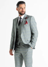 Load image into Gallery viewer, Model wearing Kensington Olive Suit faces away from camera whilst showing front details. 
