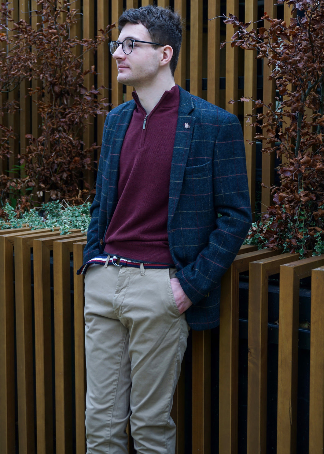Smart casual winter outfit for men with suit jacket, chinos, and a quarter-zip jumper.
