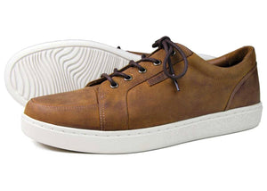 Sand brown trainers for men. One shoe is turned on the side so the grooved bottom of the sole is visible.