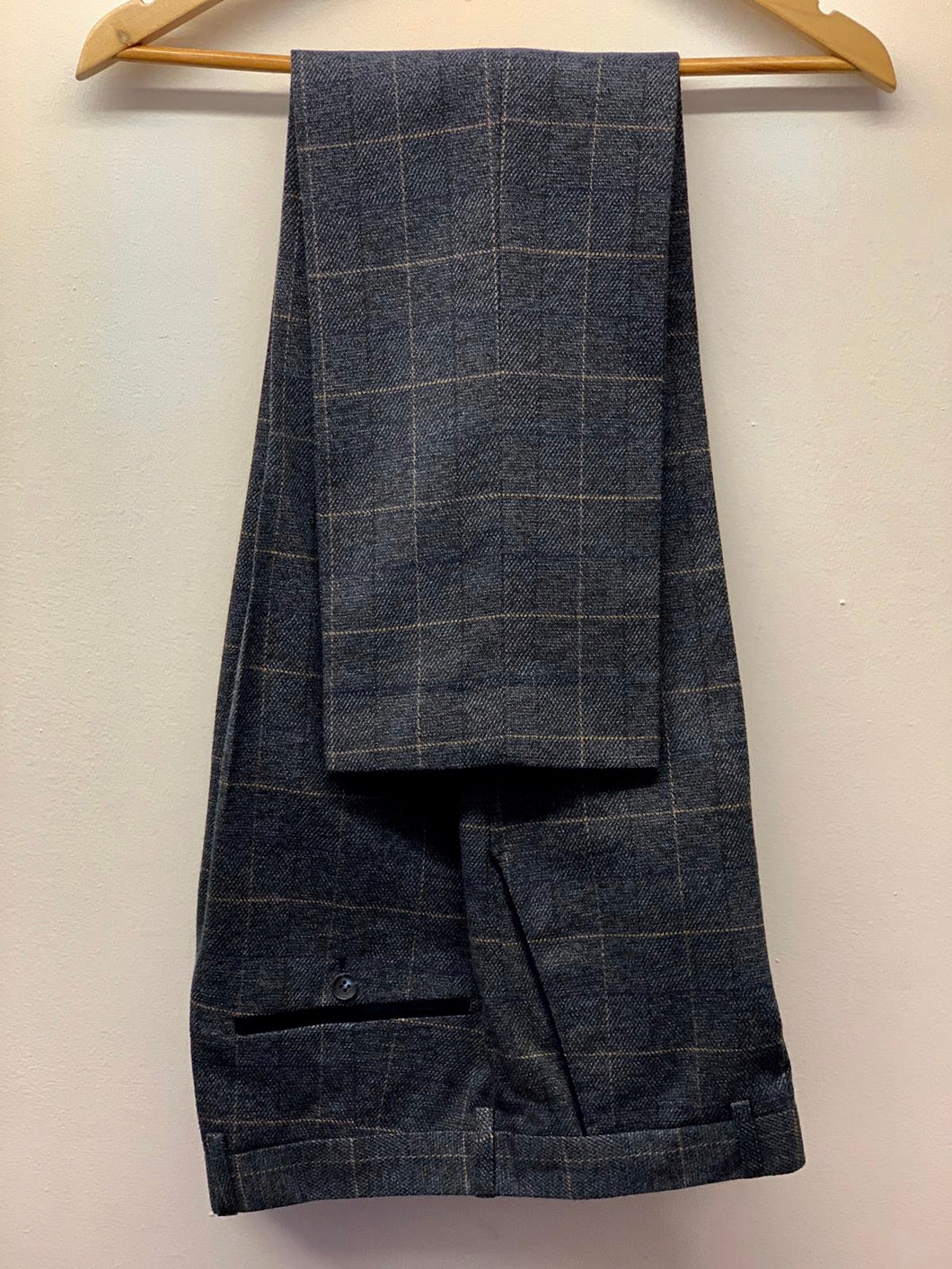 Marc Darcy Scott Blue Trousers hung up. Comfortable trousers for business attire or formal occasions.