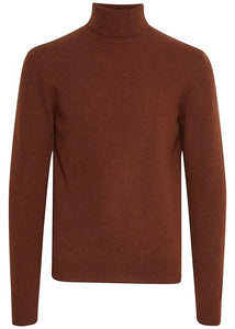 A roll neck, or turtle neck, jumper is shown against a white background. The jumper is a man's roll neck jumper in a rust colour. 