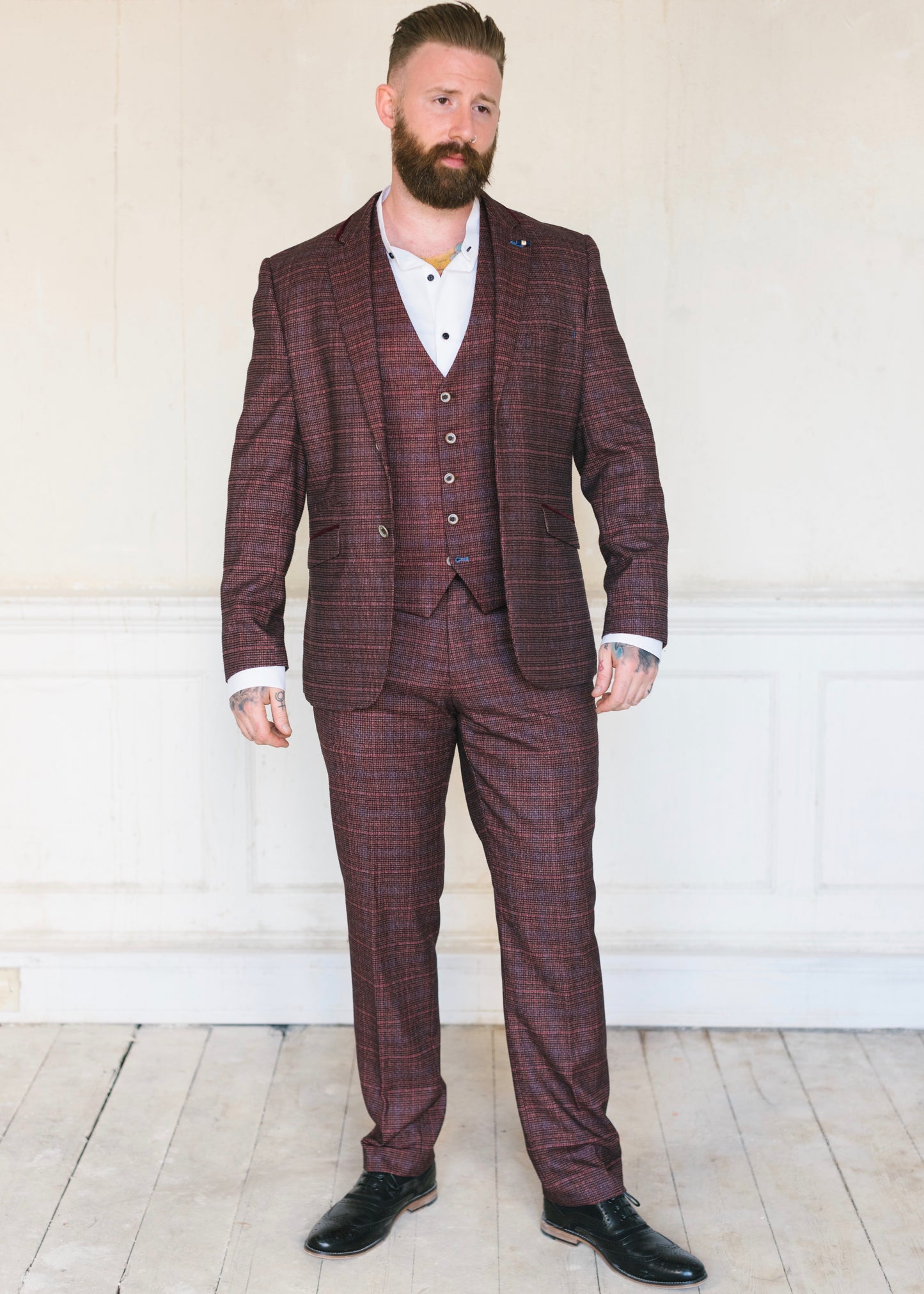 Cavani Carly Wine 3-Piece Suit consisting of jacket, trousers and waistcoat worn with a crisp white shirt and black shoes. Ideal for a wedding or another formal event or occasion.