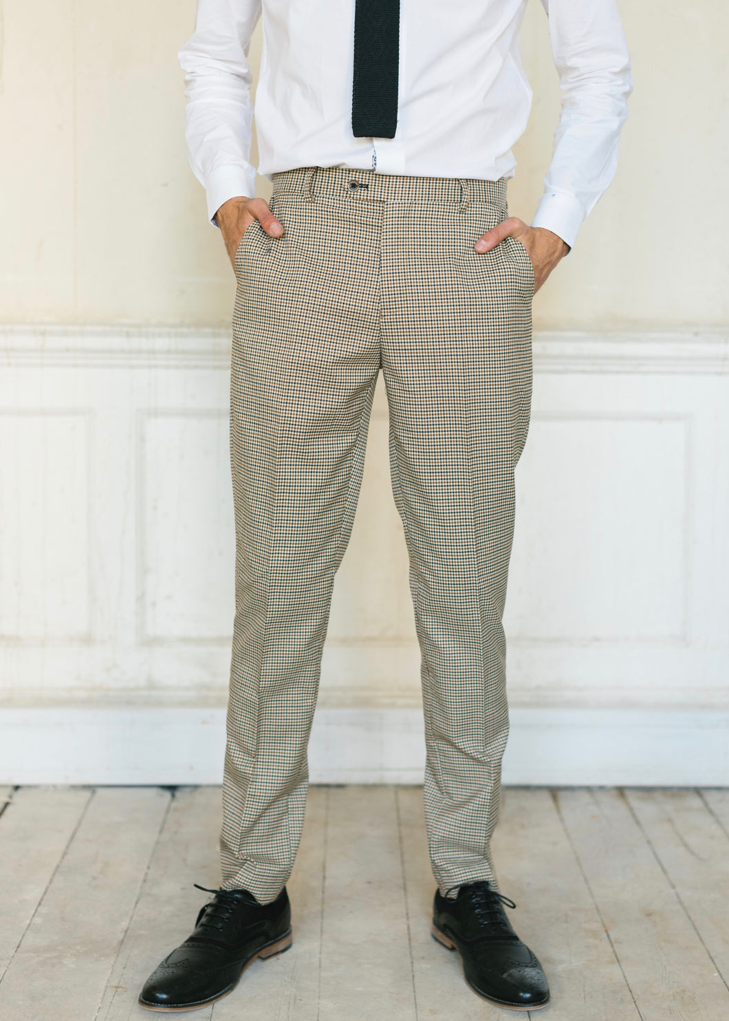 Cavani Elwood Houndstooth Checked Trousers worn with black shoes and a knit tie on a white Suave Owl crisp shirt
