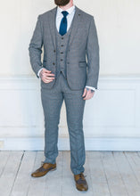 Load image into Gallery viewer, Marc Darcy Hardwick Checked Jacket modelled with a matching waistcoat and trousers. Styled with a white shirt and a blue silk tie to make it the perfect suit for a wedding or other formal occasion. Brown brogues also being worn by the model
