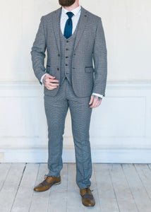 Marc Darcy Hardwick Checked Jacket modelled with a matching waistcoat and trousers. Styled with a white shirt and a blue silk tie to make it the perfect suit for a wedding or other formal occasion. Brown brogues also being worn by the model