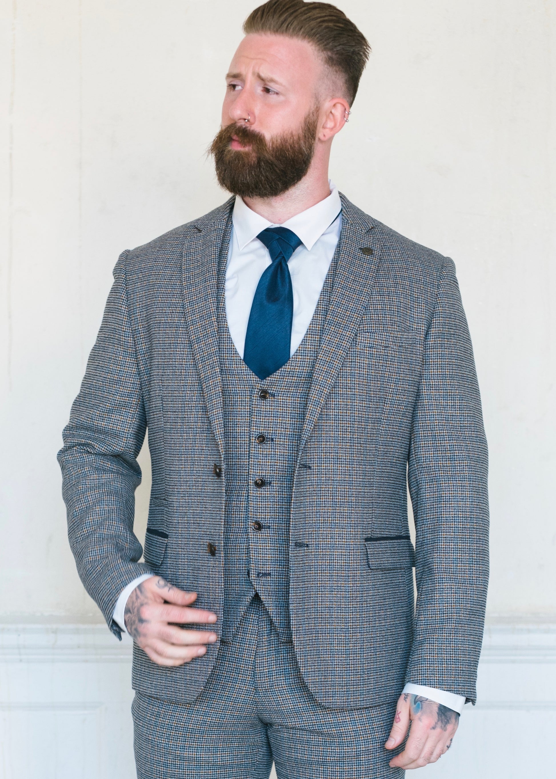 Marc Darcy Hardwick Checked Jacket modelled with a matching waistcoat and trousers. Styled with a white shirt and a blue silk tie to make it the perfect suit for a wedding or other formal occasion