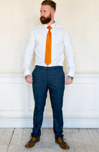 Load image into Gallery viewer, Marc Darcy Jenson Marine Checked Trousers worn with brown shoes and a vibrant orange tie
