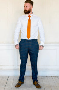 Marc Darcy Jenson Marine Checked Trousers worn with brown shoes and a vibrant orange tie