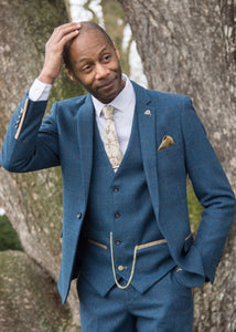 BAME model wearing Marc Darcy Dion Tweed Jacket styled with matching waistcoat and trousers. Model also wearing tie to compliment the finer details of the suit and a crisp white shirt. 